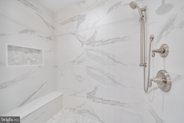 bathroom with a tile shower