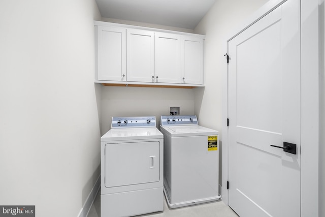 laundry area with washer hookup, cabinets, and washing machine and dryer