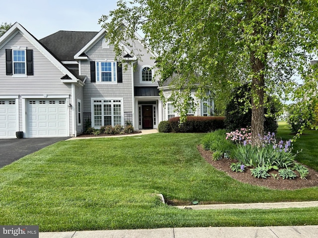 view of front facade with a front lawn and a garage