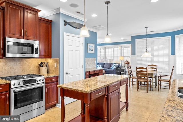 kitchen featuring light tile floors, pendant lighting, backsplash, and stainless steel appliances