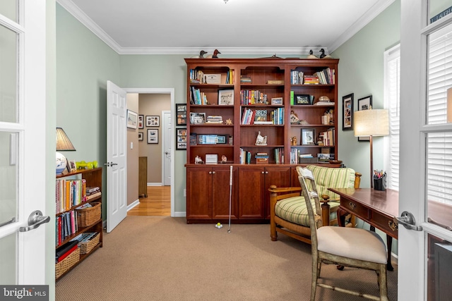 sitting room with light carpet, crown molding, french doors, and a wealth of natural light