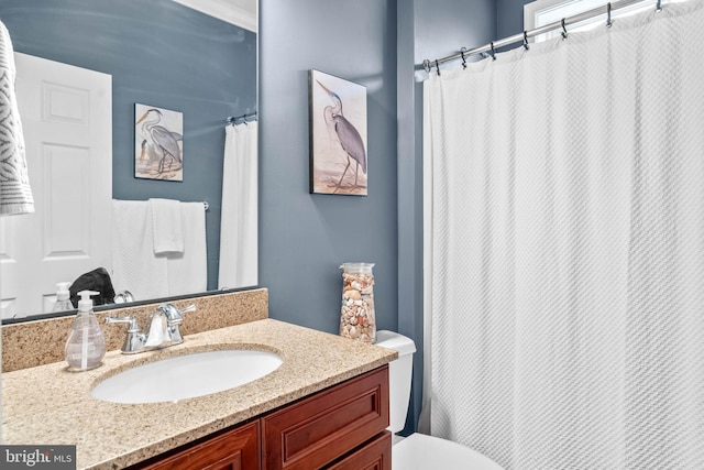 bathroom with toilet and oversized vanity