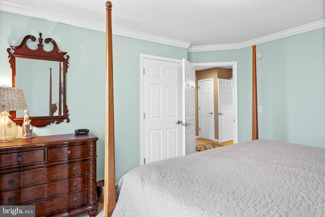 bedroom featuring light wood-type flooring and crown molding