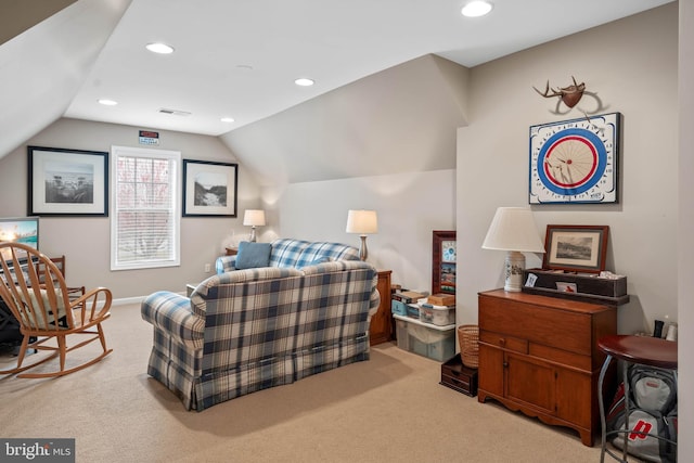 carpeted living room with vaulted ceiling