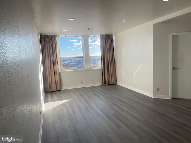 spare room featuring dark hardwood / wood-style floors