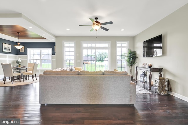 living room featuring ceiling fan and dark hardwood / wood-style floors