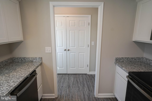 kitchen with white cabinets, light stone counters, dark hardwood / wood-style flooring, and dishwasher