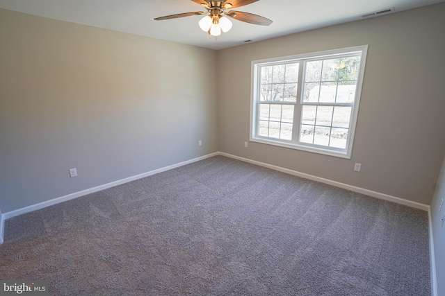 carpeted spare room with ceiling fan