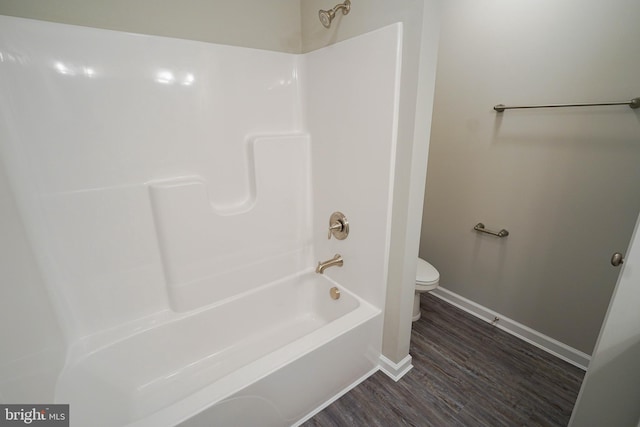 bathroom featuring toilet, shower / bathtub combination, and wood-type flooring