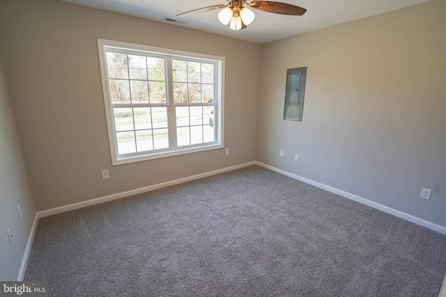 spare room featuring ceiling fan, electric panel, and carpet flooring