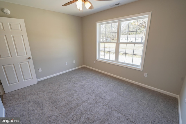 carpeted empty room featuring ceiling fan