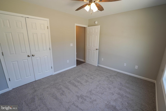 unfurnished bedroom featuring ceiling fan, a closet, and carpet flooring