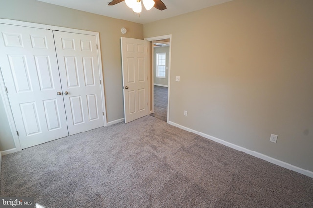 unfurnished bedroom featuring ceiling fan, a closet, and carpet floors