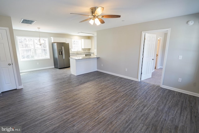 unfurnished living room with ceiling fan and dark hardwood / wood-style floors