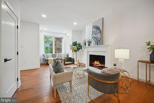 living room with light wood-type flooring and a fireplace