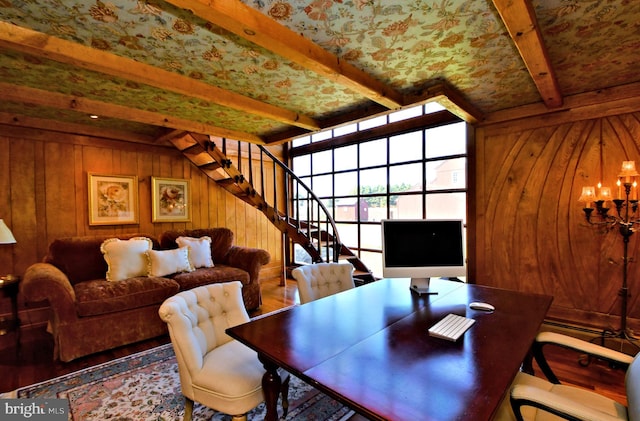 dining space with wooden walls, beamed ceiling, and hardwood / wood-style floors