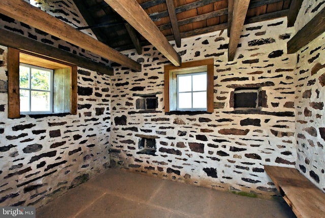 interior space with beam ceiling and plenty of natural light