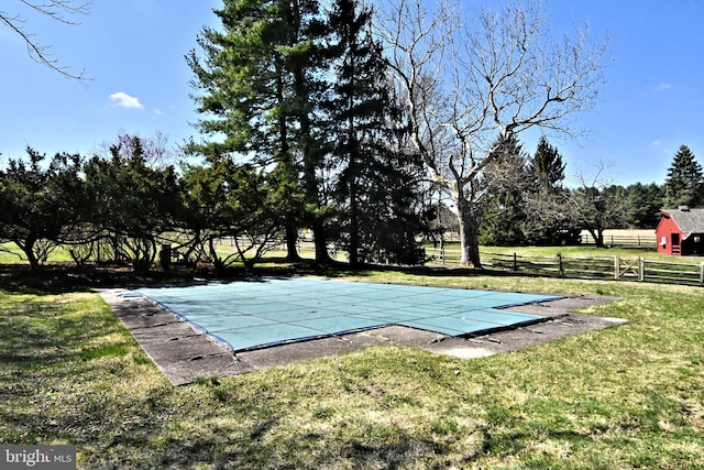 view of swimming pool with a lawn