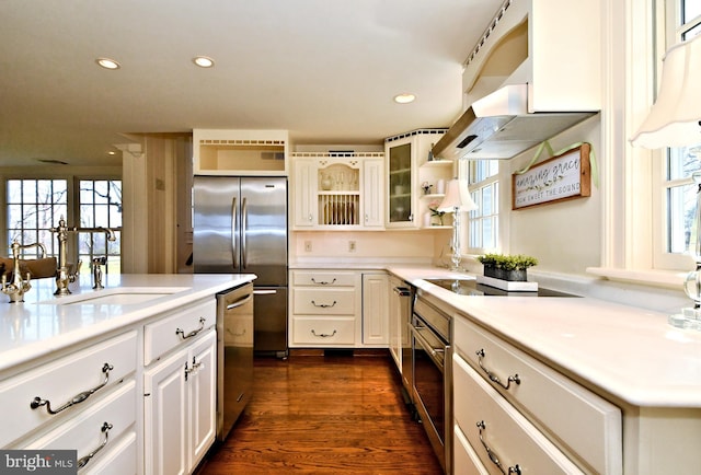 kitchen featuring dark hardwood / wood-style floors, appliances with stainless steel finishes, white cabinets, and sink