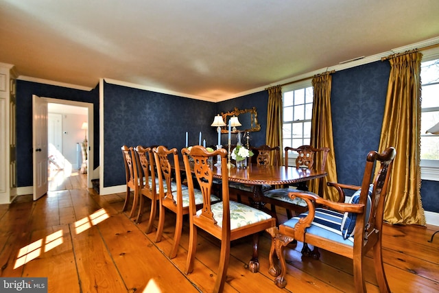 dining room with crown molding and hardwood / wood-style floors