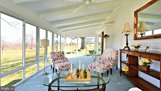 sunroom / solarium featuring ceiling fan, vaulted ceiling with beams, and a wealth of natural light