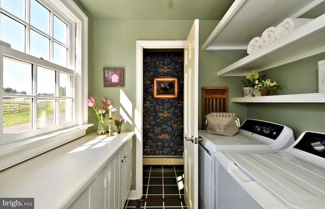 laundry area with tile floors and separate washer and dryer