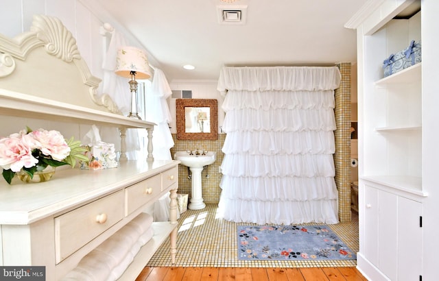 interior space featuring light wood-type flooring and ornamental molding