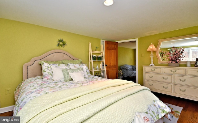 bedroom with dark wood-type flooring