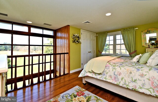 bedroom with dark hardwood / wood-style flooring