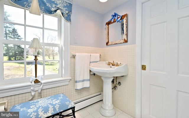 bathroom with a baseboard heating unit, tile floors, and tile walls