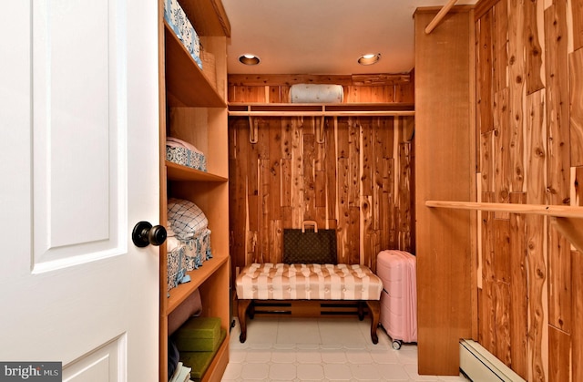 walk in closet featuring baseboard heating, light tile floors, and radiator heating unit