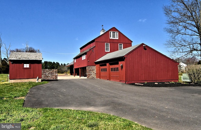 view of front of property with a garage and an outdoor structure