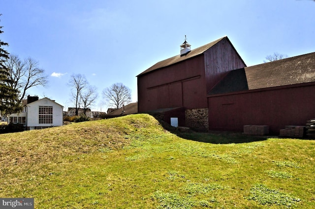 view of side of home with a yard