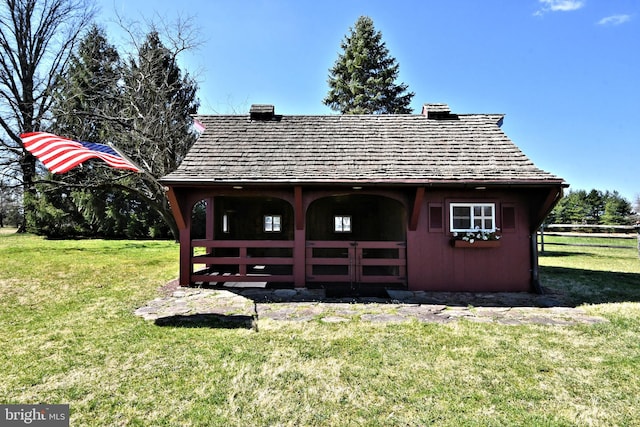 exterior space with a lawn and an outdoor structure