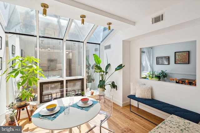 sunroom with vaulted ceiling with beams