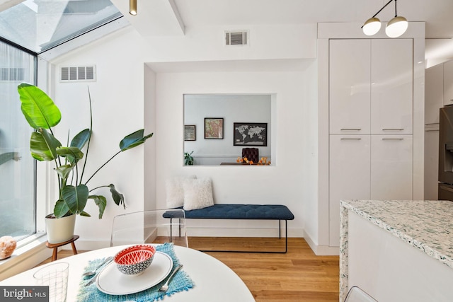 interior space with an inviting chandelier and light hardwood / wood-style flooring