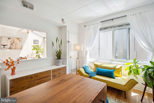 sitting room with a textured ceiling and hardwood / wood-style flooring