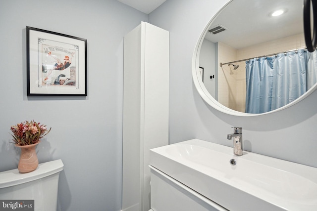 bathroom with toilet and vanity