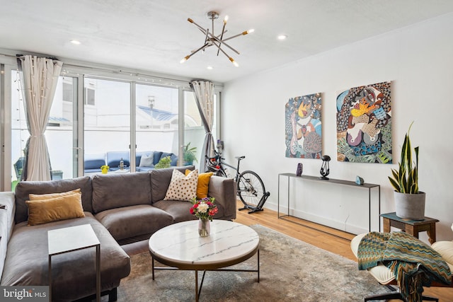 living room featuring a chandelier and light hardwood / wood-style flooring