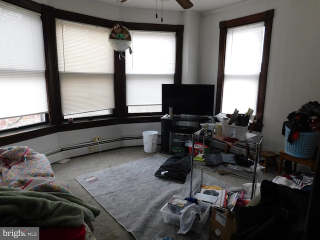 carpeted living room featuring ceiling fan and a baseboard heating unit