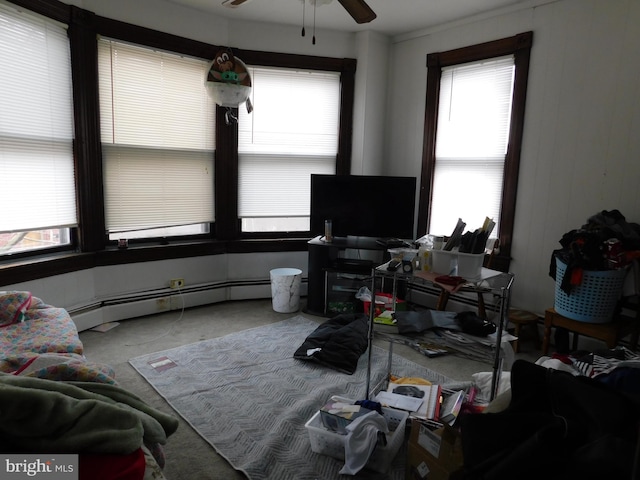 living room featuring a baseboard radiator, ceiling fan, and light colored carpet