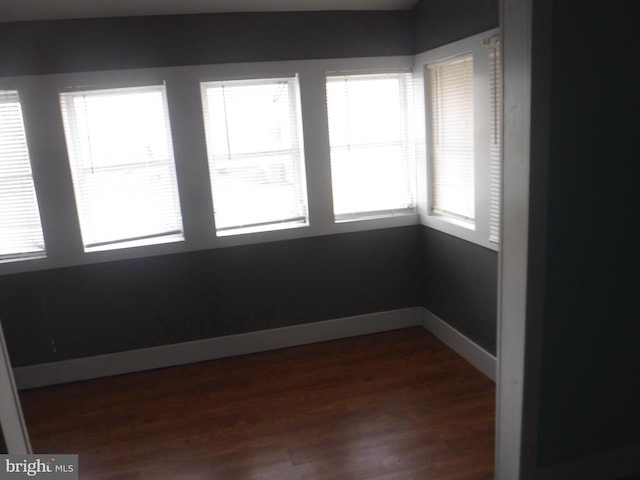 unfurnished room with dark hardwood / wood-style flooring