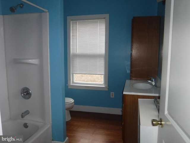 full bathroom with toilet, bathing tub / shower combination, vanity, and hardwood / wood-style floors