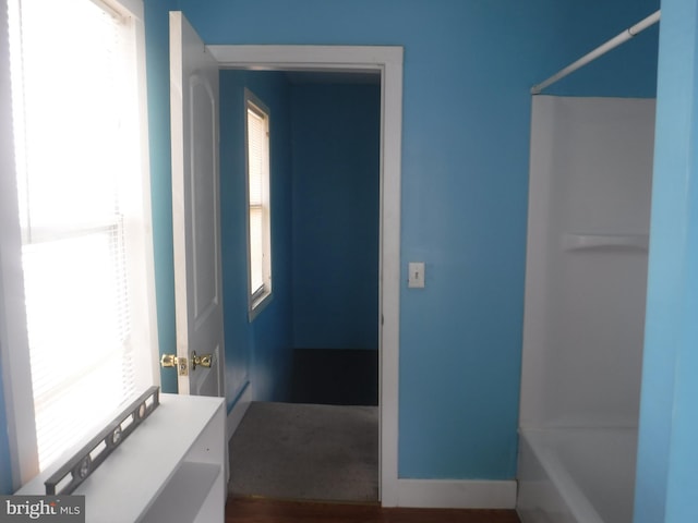 bathroom with tub / shower combination and plenty of natural light