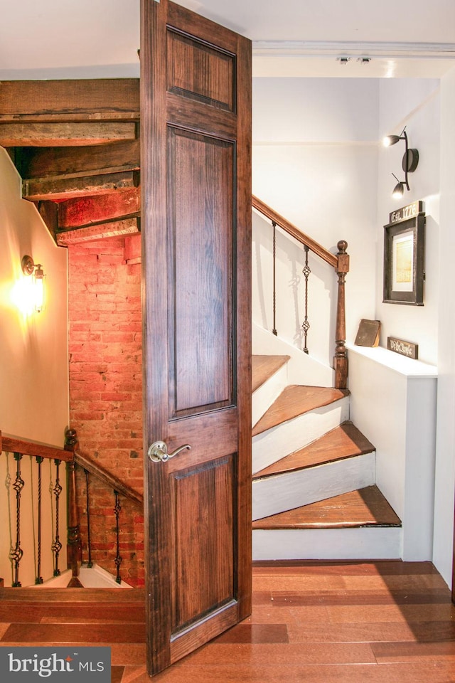 stairway featuring dark wood-type flooring