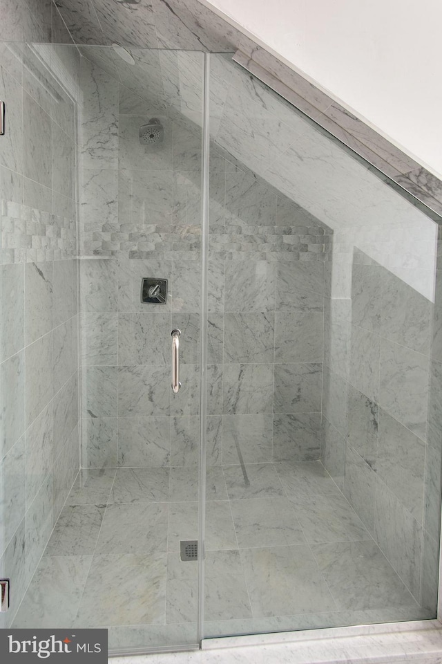 bathroom featuring a shower with shower door