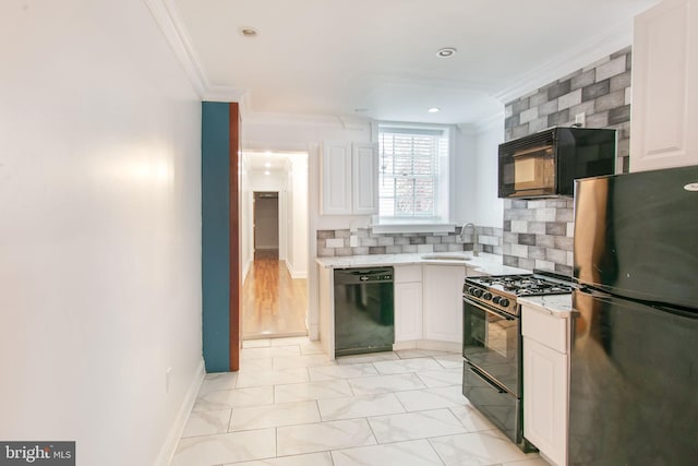 kitchen featuring light tile flooring, black appliances, white cabinets, sink, and ornamental molding