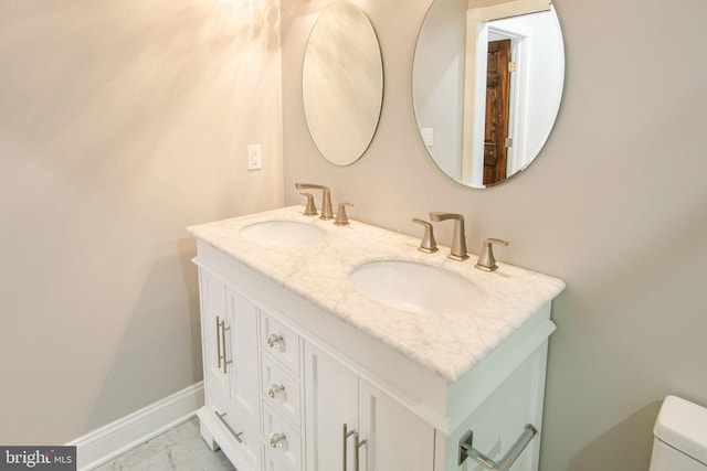 bathroom featuring tile flooring, double sink vanity, and toilet