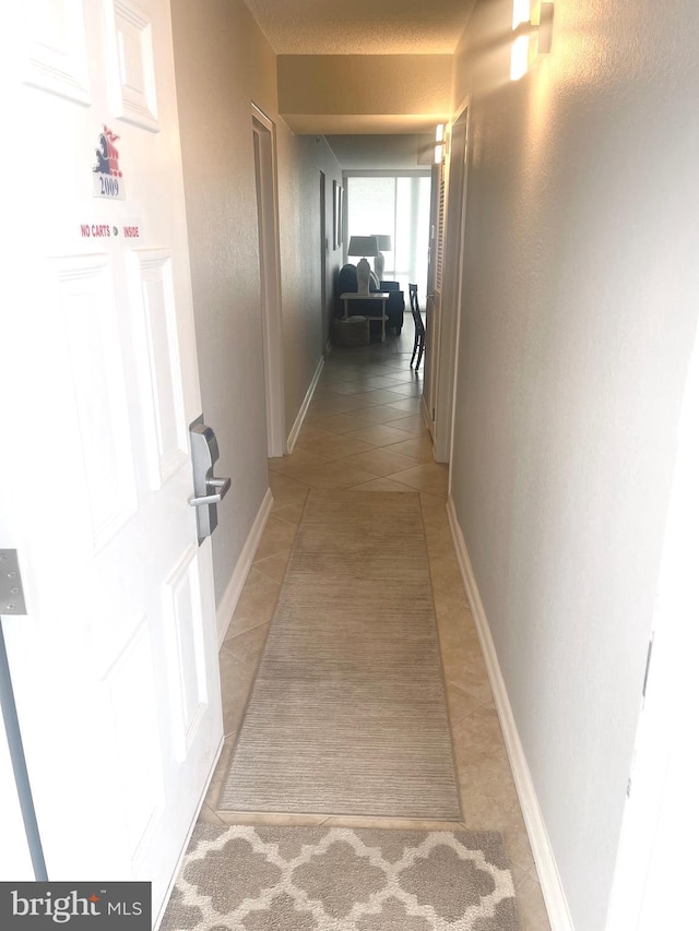 corridor with light tile patterned floors