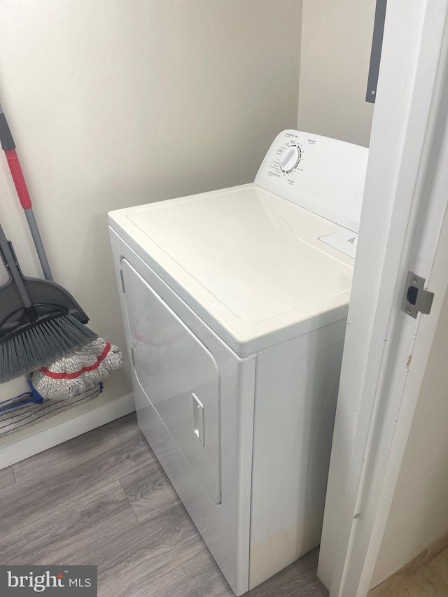 washroom with light wood-type flooring and washer / clothes dryer